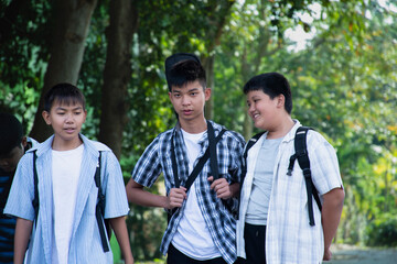 Young asian boys are walking homes afterschool together, soft and selective focus, concept for teen lifestyle and teenagers's spending times.