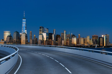 Obraz premium Empty urban asphalt road exterior with city buildings background. New modern highway concrete construction. Concept of way to success. Transportation logistic industry fast delivery. New York. USA.