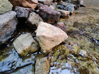 A small stream in the campsite and stones along the creek.