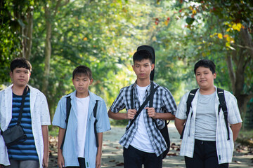 Young asian boys are walking homes afterschool together, soft and selective focus, concept for teen...