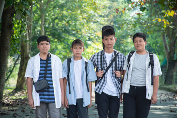 Young asian boys are walking homes afterschool together, soft and selective focus, concept for teen lifestyle and teenagers's spending times.