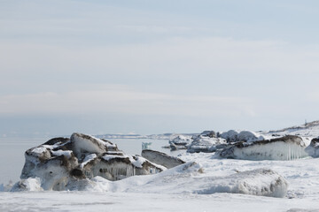 Sea ice on snowy beach in winter