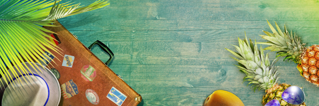 Nautical concept with palm leaf, beach hat, seashells and pineapple.