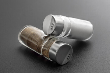 Salt and pepper shakers on a black.