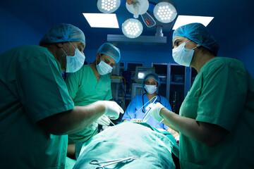 ndian surgeons medical team performing surgery in operation theater at hospital. Medical care concept.