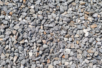 A floor full of gravel stones. sunlight