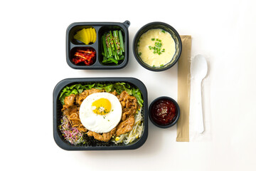 Spicy stir-fried meat and side dishes in a take-out container