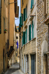 Fototapeta na wymiar Gothic buildings on a narrow street in Centro Storico of Florence, Italy