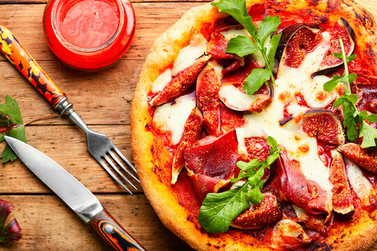 Homemade meat pizza with figs.