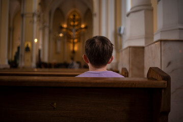 boy, schoolboy, child praying in catholic church