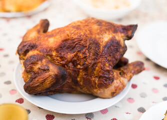 ruddy chicken fried whole on a plate on the festive table