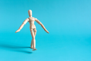 A cautious person takes a step forward. The wooden doll takes a step.