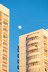 Moscow, Russia - May 01, 2023: moon in the sky between houses.