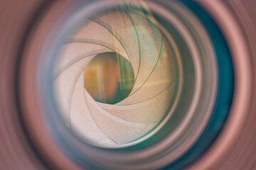 Camera lens aperture close up, front of digital camera lens. Abstract photography equipment...