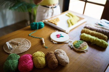 Punch needle. Asian Woman making handmade Hobby knitting in studio workshop. designer workplace Handmade craft project DIY embroidery concept.