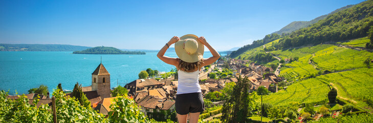 Beautiful landscape view of lake with woman tourist in Switzerland- Village, vineyard and lake