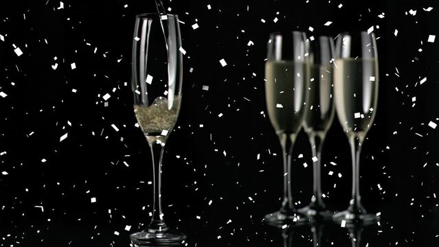 Animation of falling confetti over champagne getting poured in flute glass against black background