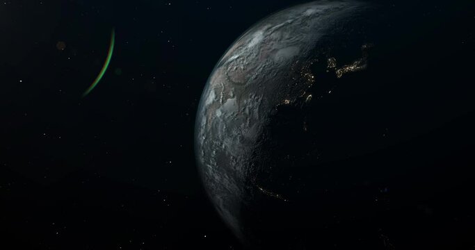 Planet Earth in open space, with a clearly visible terminator line dividing the planet into the bright daylight side and the dark nighttime side. The nighttime side showcases the lights of cities.
