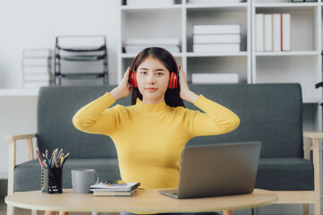 Asian woman enjoy listening to music and drinking coffee and laptop computer in the morning