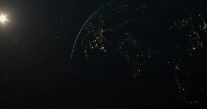 Planet Earth in open space, with a clearly visible terminator line dividing the planet into the bright daylight side and the dark nighttime side. The nighttime side showcases the lights of cities.