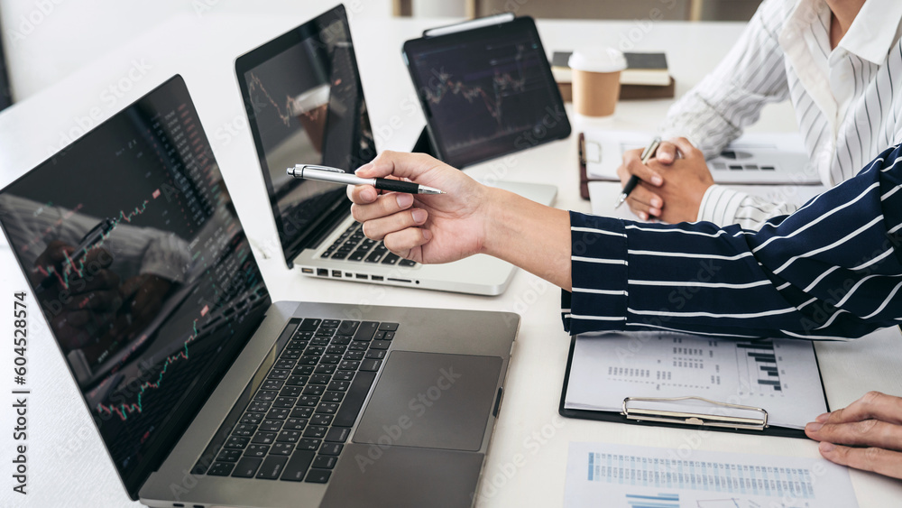 Leinwandbilder Business trader team pointing statistics graph and checking stoc