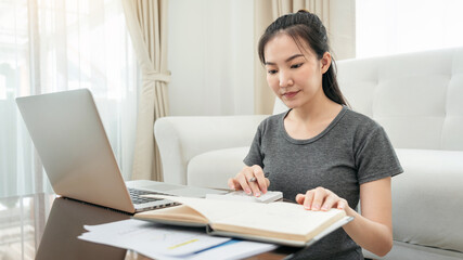 Asian freelance woman using laptop to receive order from client