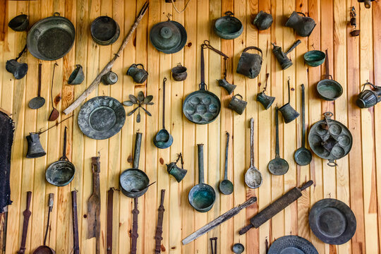 Ancient kitchen utensil hanging on wall. Kitchenware of the yoruk tribe