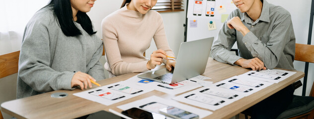 UX graphic designer planning application process development prototype wireframe for web smart phone. Creative digital development agency. in office