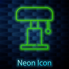 Glowing neon line Table lamp icon isolated on brick wall background. Vector