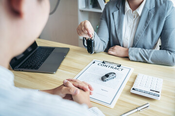 Salesman agent sending a key to customer after the good deal agr