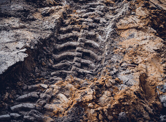 Excavator tire tracks footprint on construction road site