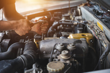 Fototapeta na wymiar Hands of car mechanic in auto repair service.