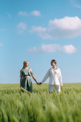 Two fashion woman in the green field. Fashion concept. Beautiful figures. Summer concept.