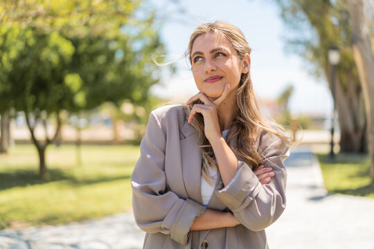 Young pretty blonde Uruguayan woman at outdoors thinking an idea while looking up