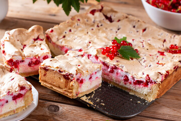 Appetizing homemade berry pie. Pie with red currants and sour cream on wooden table