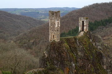 The two towers of the lower castle perched on the Roc del Thaluc, the "sugar loaf", in Peyrusse-le-Roc, on a March morning (Aveyron, Occitanie, France)