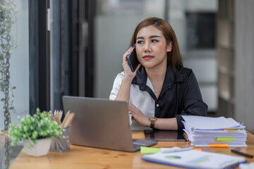 Young asian woman, professional entrepreneur standing and call phone in office clothing, smiling and looking confident, workplace background
