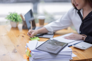 Business Asian woman working at office with documents on his desk, doing planning analyzing the financial report, business plan investment, finance analysis concept	