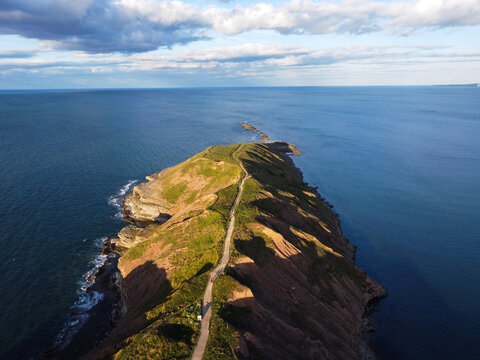 Filey Brigg is a long narrow peninsula situated about a mile north of Filey, North Yorkshire. Its steep cliffs are 20 metres high and consist of a variety of material, from pure sandstone to pure lime