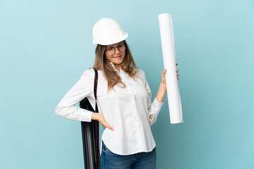 Slovak architect girl holding blueprints isolated on blue background suffering from backache for having made an effort