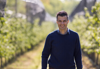 Farmer walking in orchard