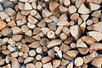 Harvesting chopped firewood. Abstract wooden background. Coarse wood