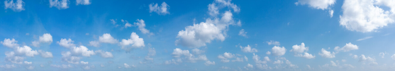 Naklejka na ściany i meble Panoramic sky on a sunny day. light blue sky panorama. background. blue sky with tiny clouds.