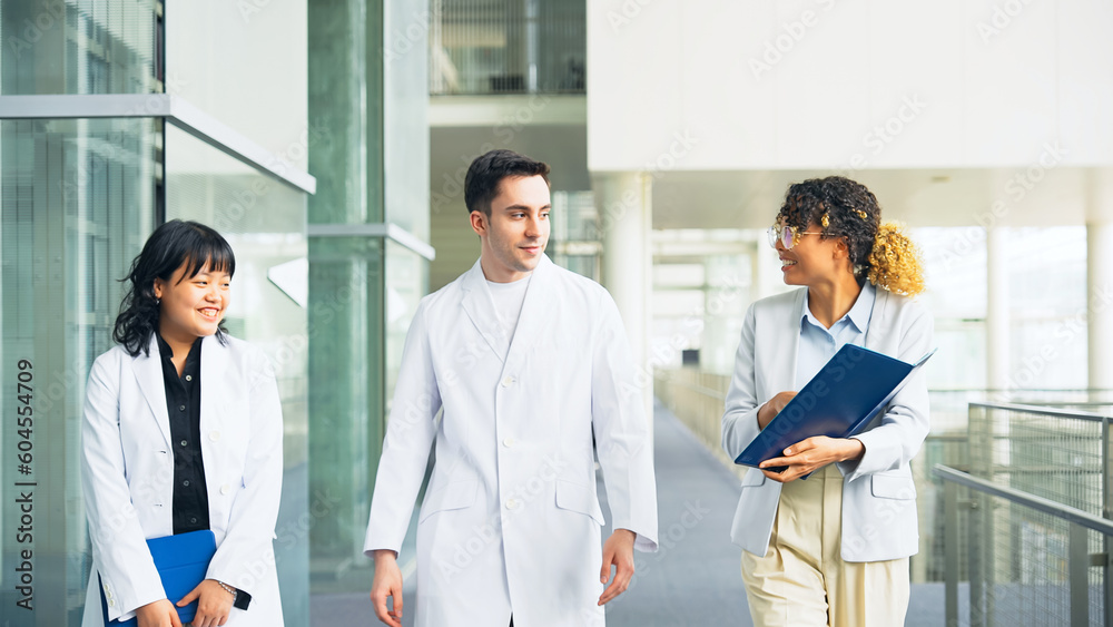 Poster a multinational group having a conversation in the lobby. people in white coats and sales staff.