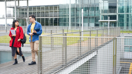 Multinational youth group walking in outdoor facility.