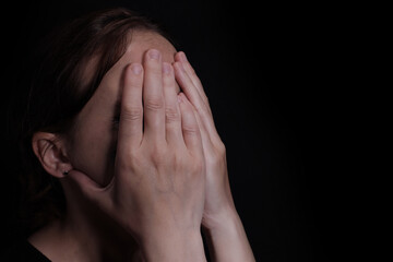 young crying woman crying covering her face with her hands