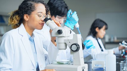 Multinational researcher group experimenting in the lab.