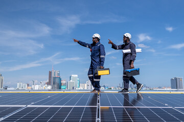 Fototapeta na wymiar Engineers walking on roof inspect check and Maintenace solar cell panel by hold blue print ,solar cell is smart grid ecology energy sunlight alternative power factory concept.