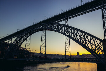 Sunset view with Dom Luis I Bridge connected cities of Porto and Vila Nova de Gaia in Portugal