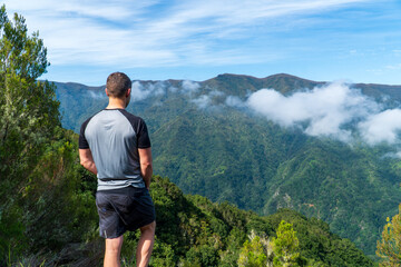 Fototapeta premium the main subject is out of focus, Madeira holiday summer trip vacation tourism mountains sunny day green trees landscape single man male sit relax